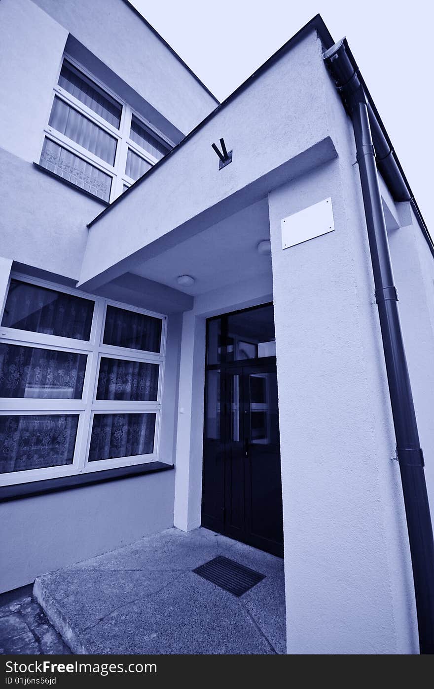 A blue toned photo of a school building entrance. A blue toned photo of a school building entrance.