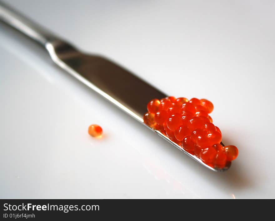 Delicious salmon red caviar and a knife