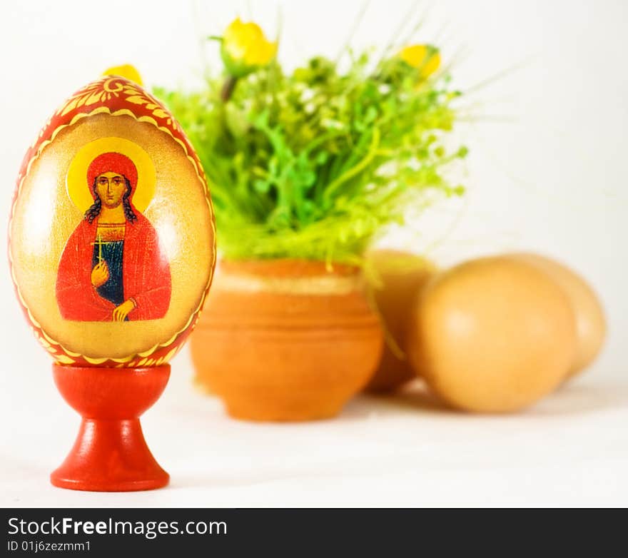 Easter and religion - painted egg and ornaments over white