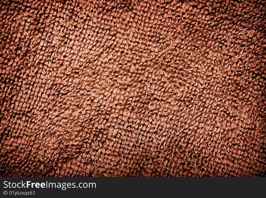 Abstract background: macro view of textured brown textile. Abstract background: macro view of textured brown textile