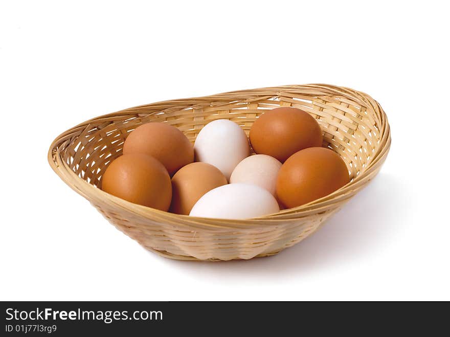 Chicken eggs are in a small basket