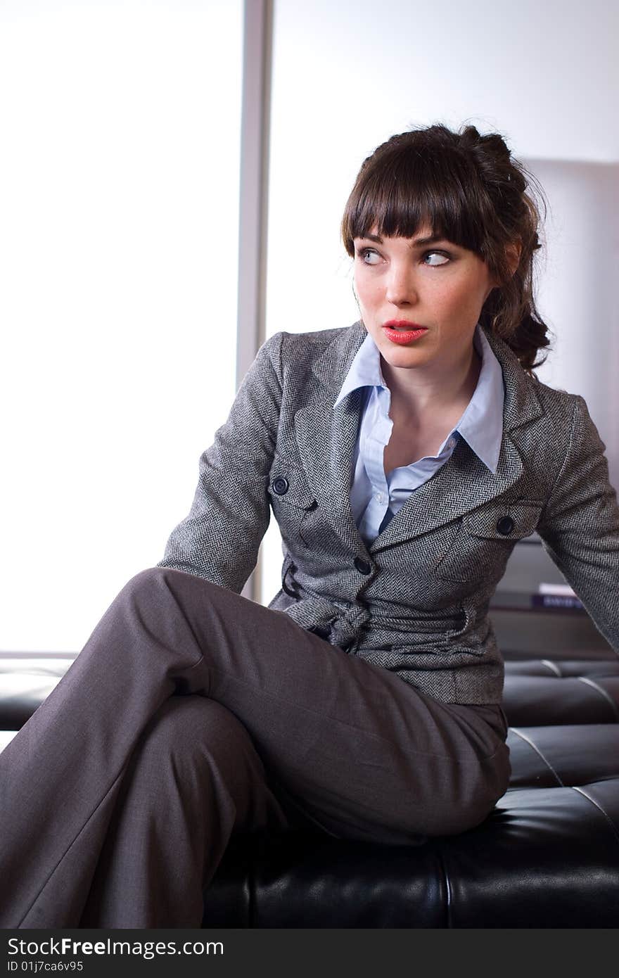 Business woman sitting in a modern office. Business woman sitting in a modern office