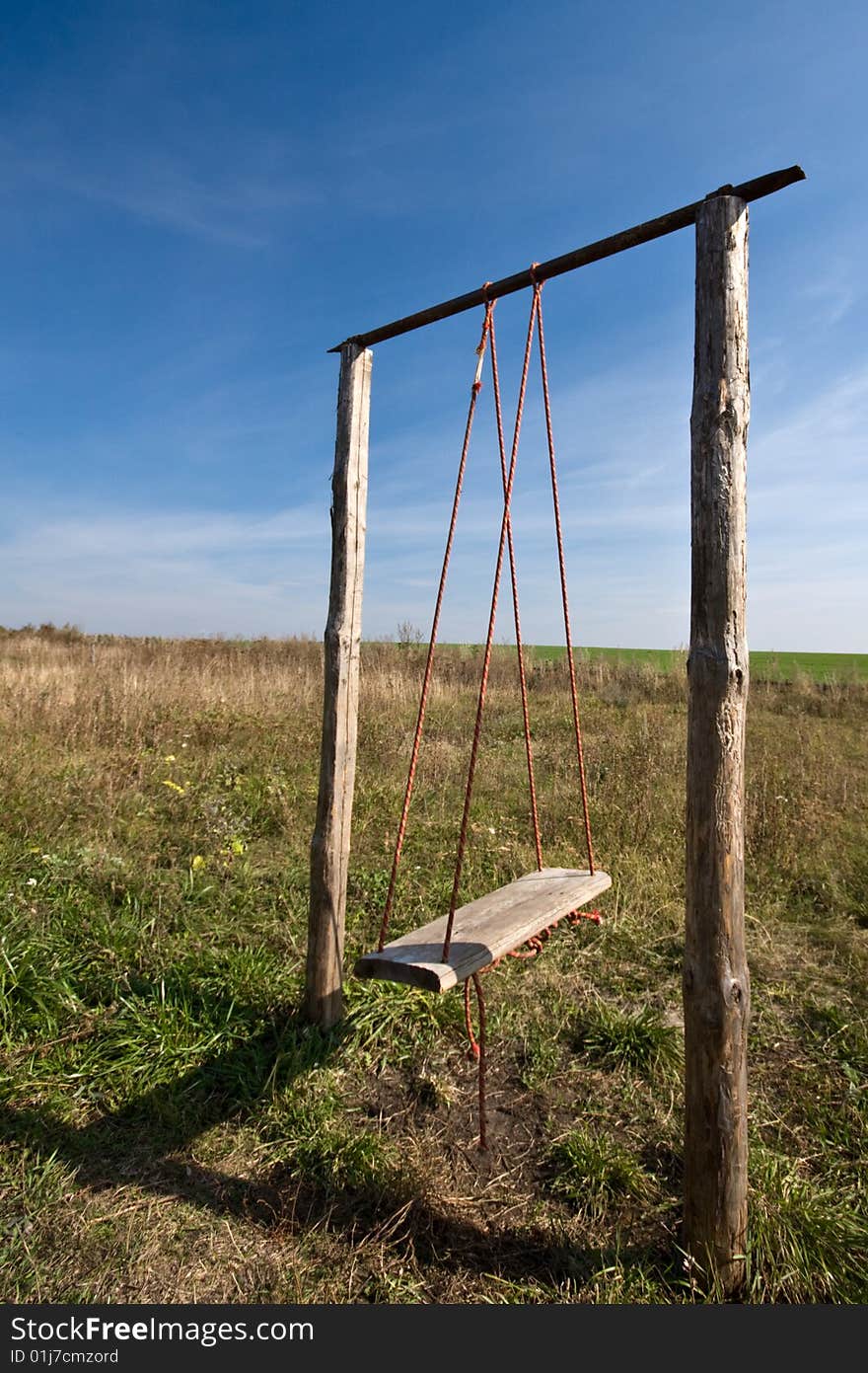 Wooden swing in the field