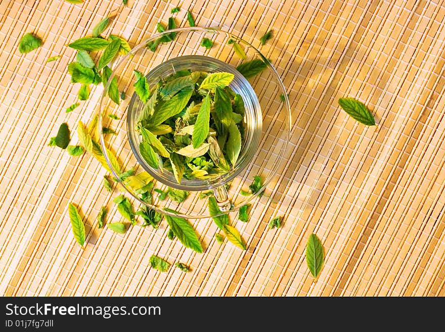 Cup full of leaves - green tea freshness.