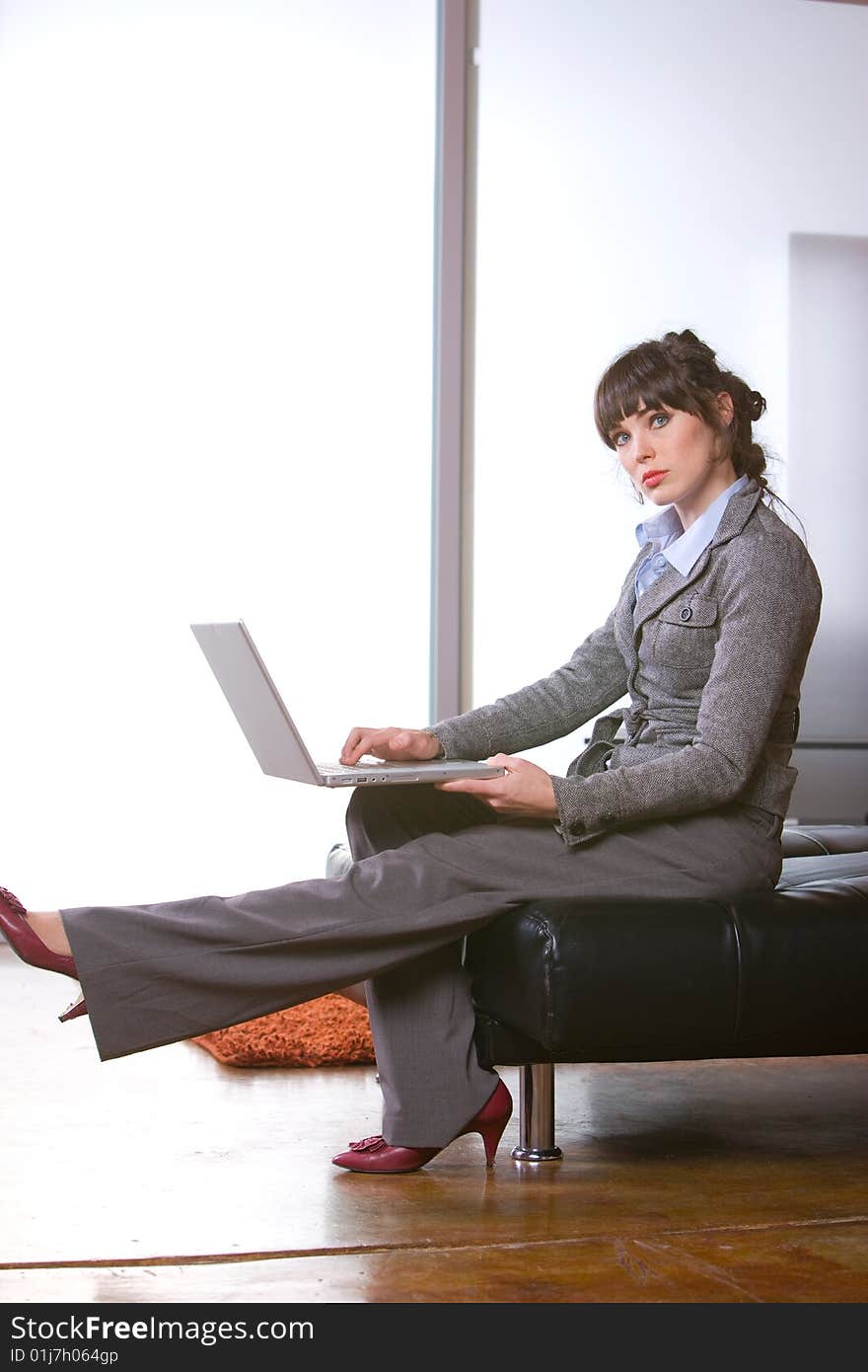 Business woman sitting in a modern office. Business woman sitting in a modern office