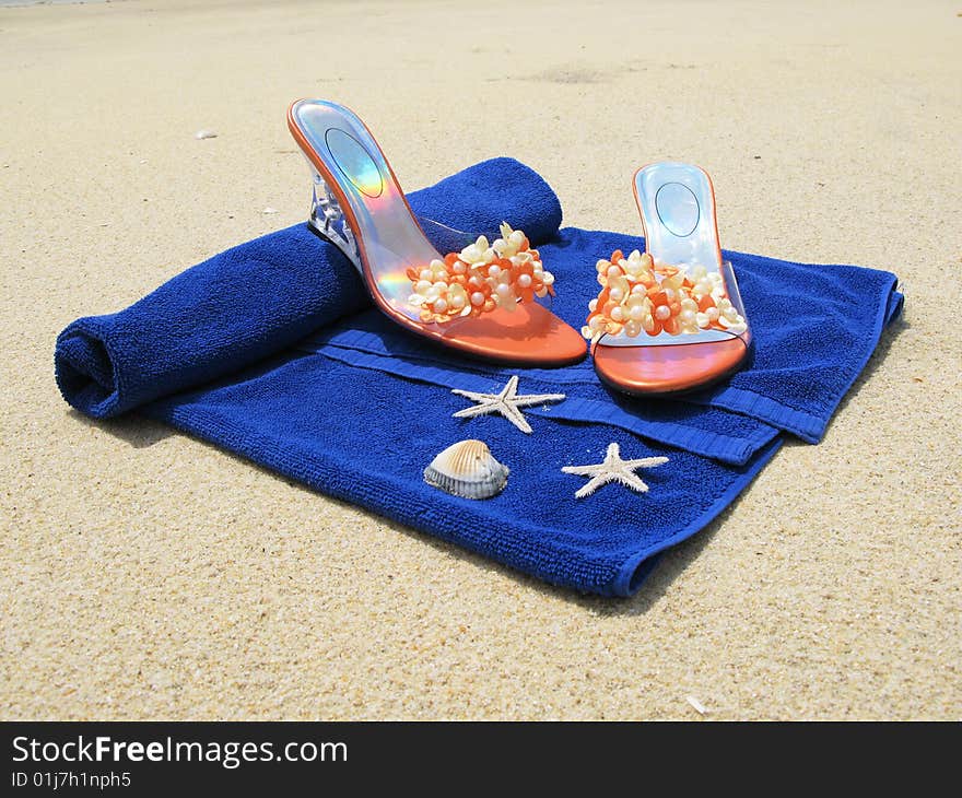 Beach towel with shoes on it. Beach towel with shoes on it