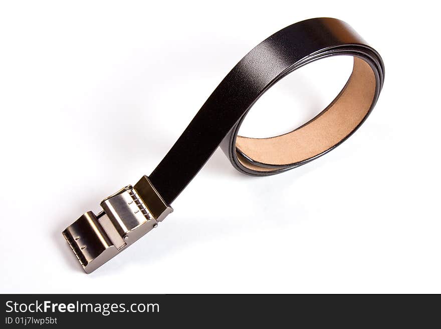 A black  leather belt isolated on white background. A black  leather belt isolated on white background