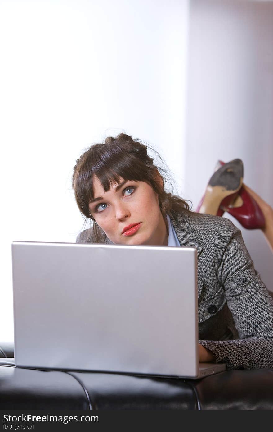 Business Woman on laptop in a modern loft office. Business Woman on laptop in a modern loft office