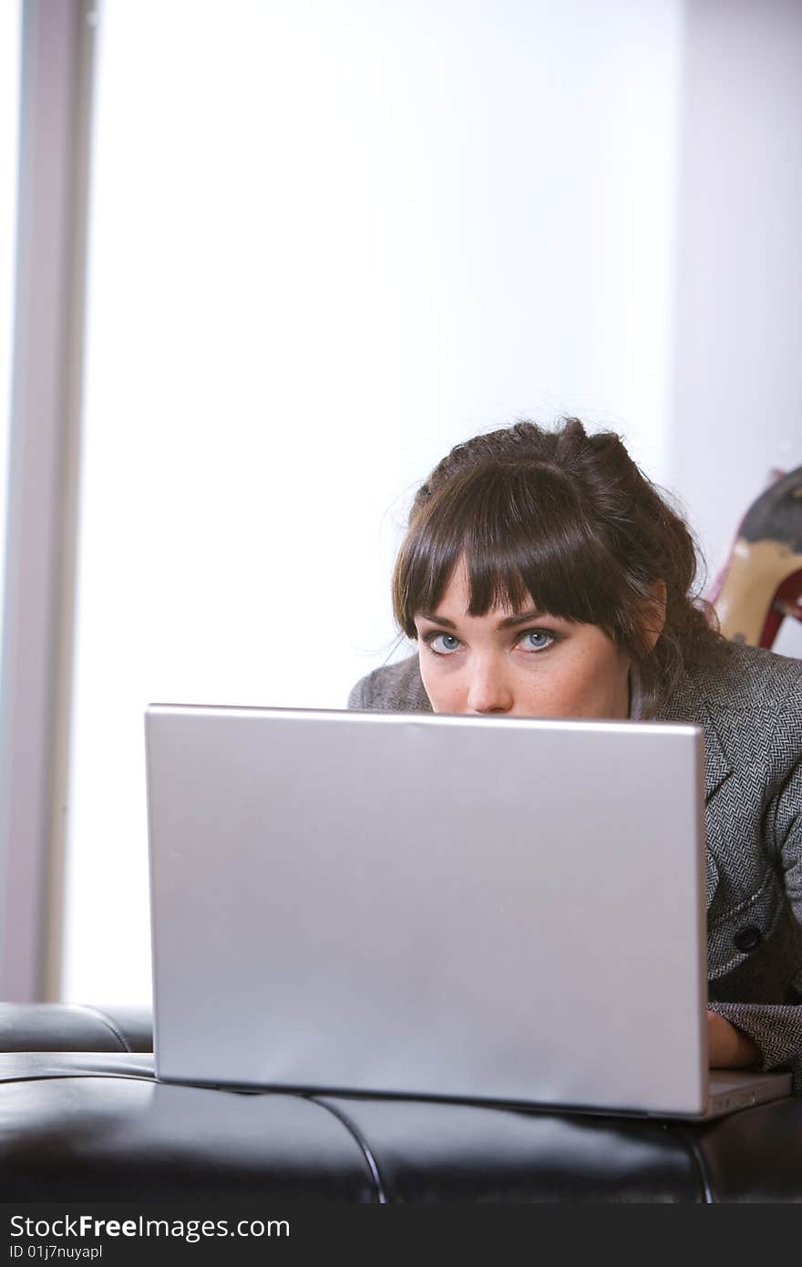 Business Woman on laptop in a modern loft office. Business Woman on laptop in a modern loft office