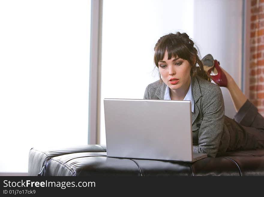 Business Woman on laptop in a modern loft office. Business Woman on laptop in a modern loft office