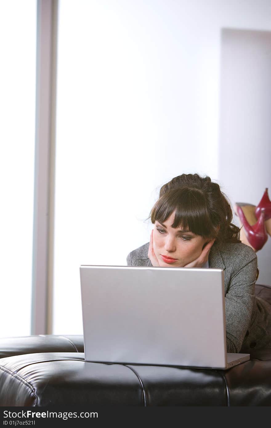 Business Woman on laptop in a modern loft office. Business Woman on laptop in a modern loft office