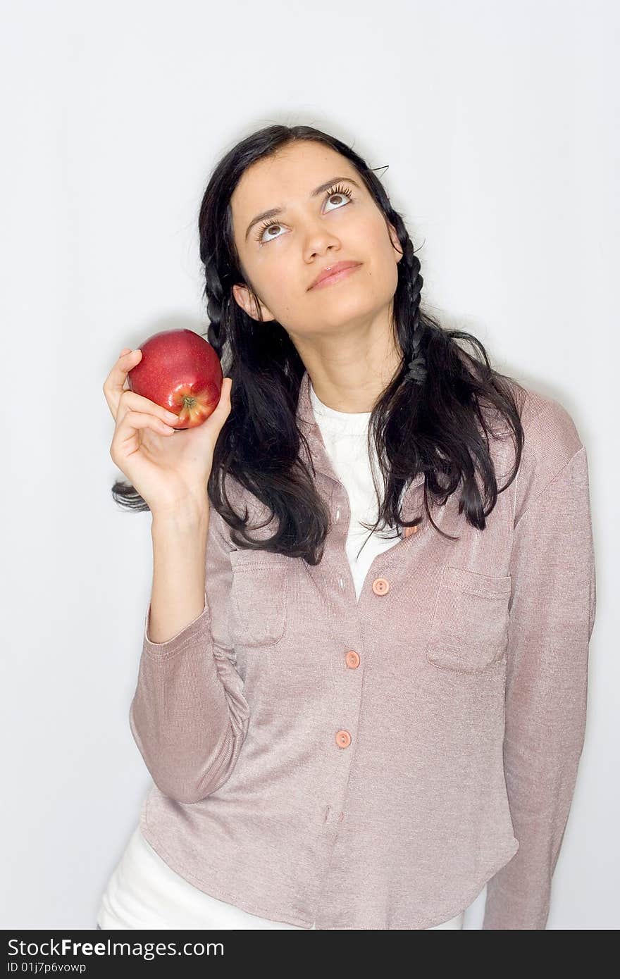 Portrait of smiling young woman holding apple, isolated on white background