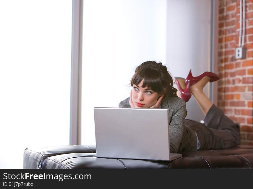 Business Woman on laptop in a modern loft office. Business Woman on laptop in a modern loft office