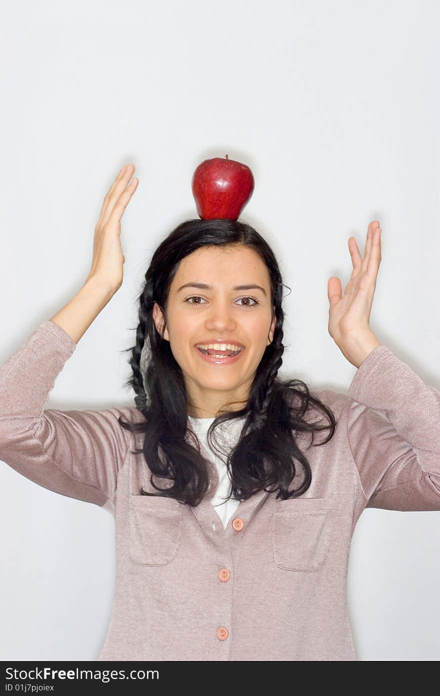 Portrait of smiling young woman holding apple, isolated on white background