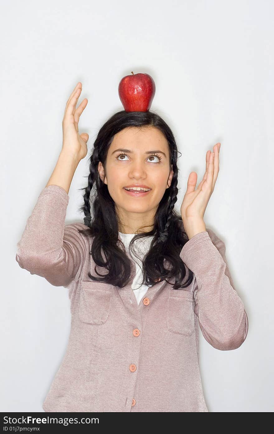 Portrait of smiling young woman holding apple, isolated on white background