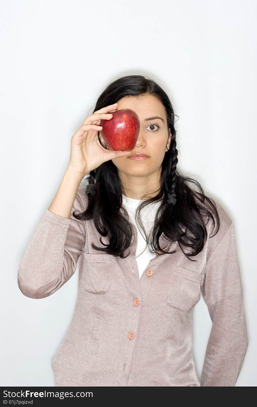 Portrait of smiling young woman holding apple, isolated on white background