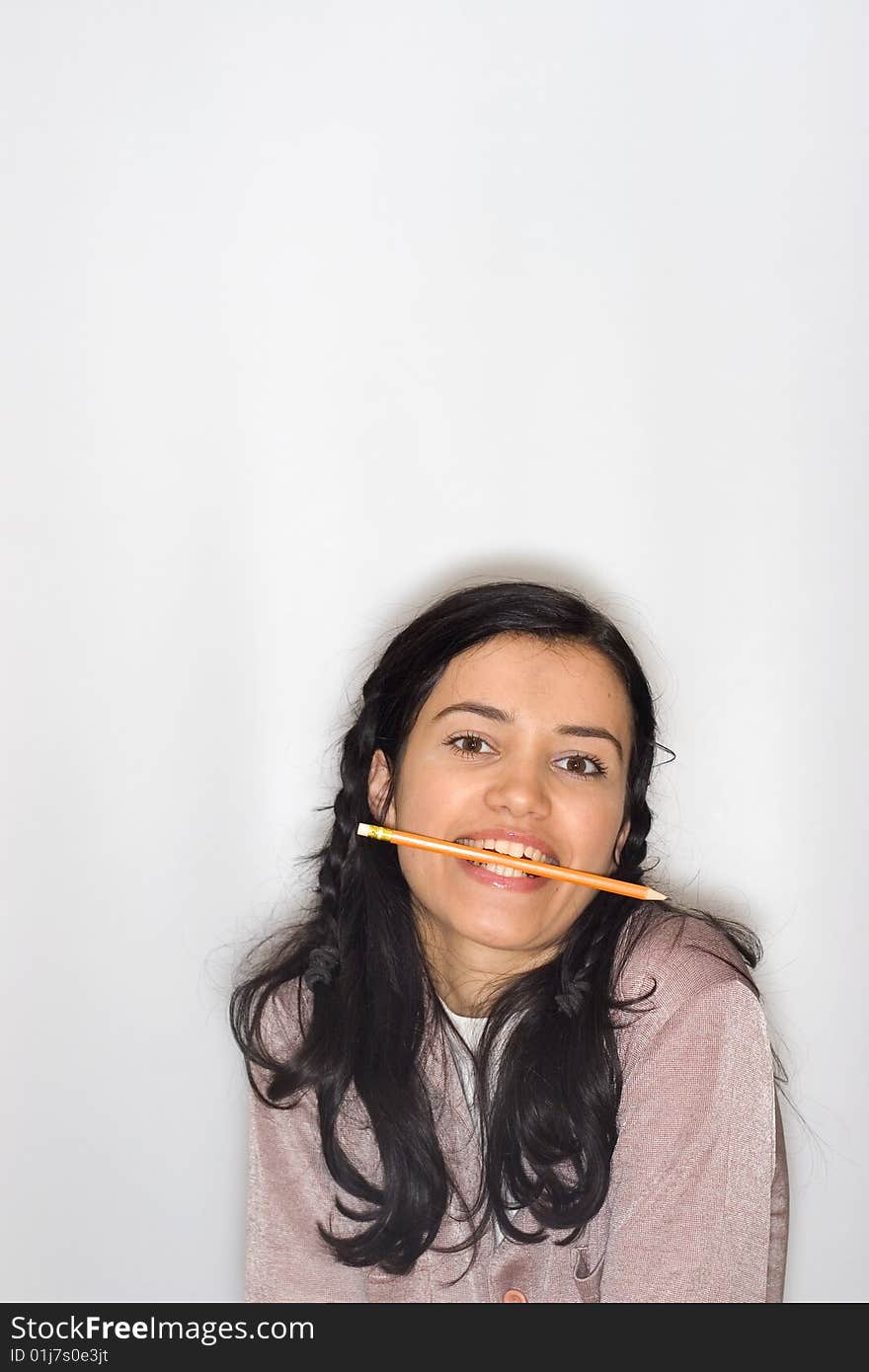 Young woman with pencil in her mouth