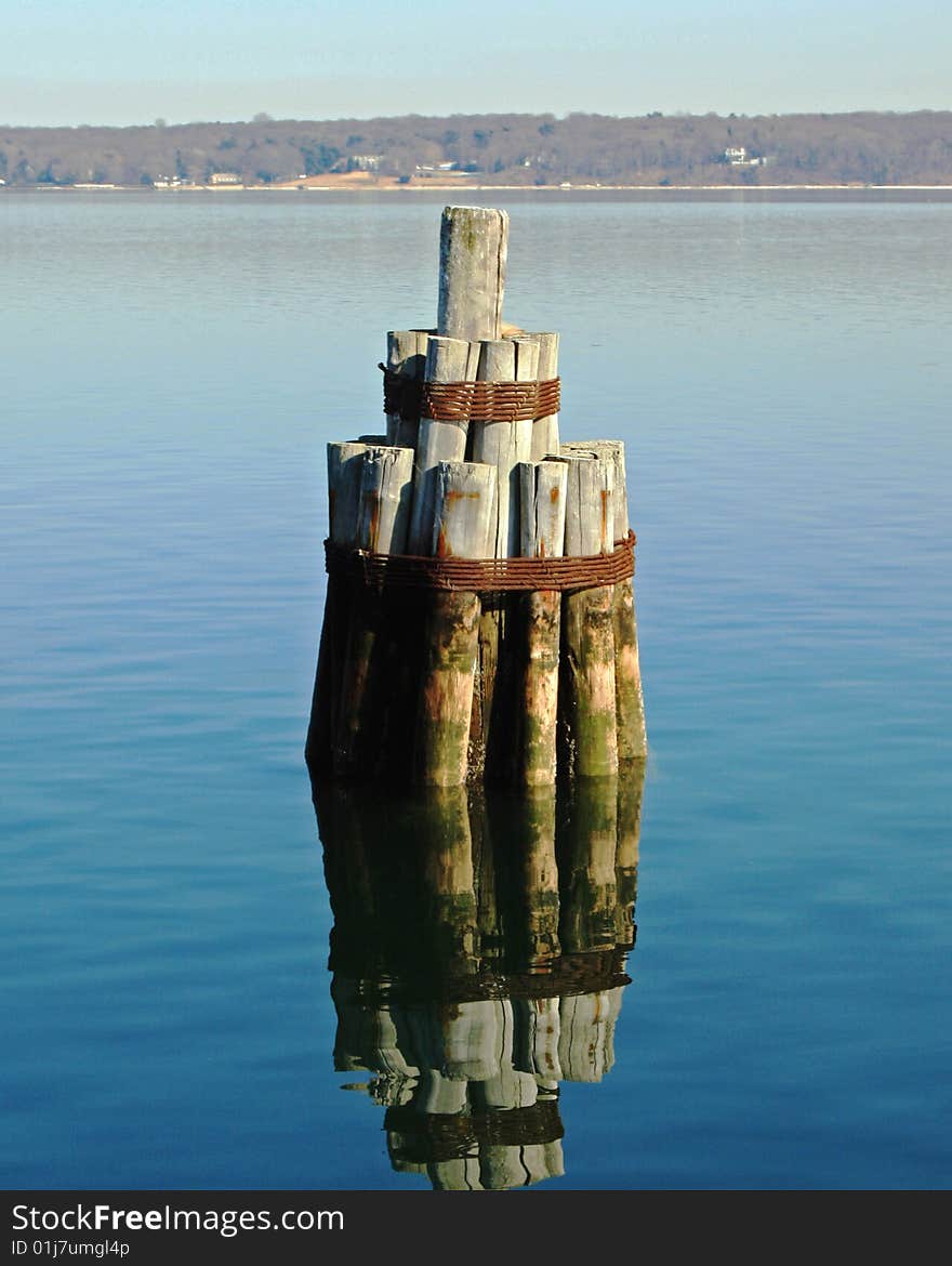 Wooden piles bound together to form a fender system for docking ships. Wooden piles bound together to form a fender system for docking ships.