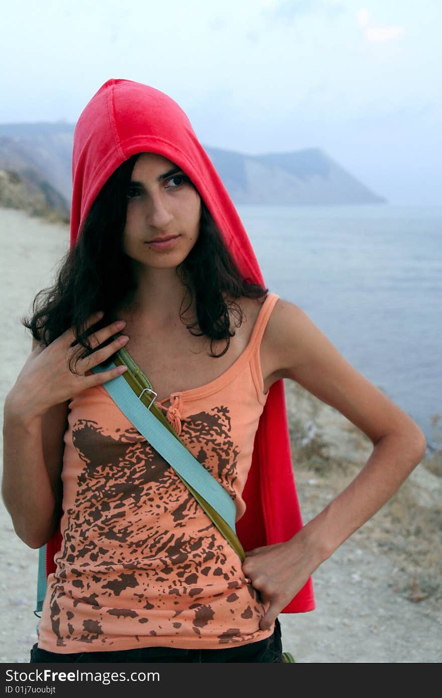 A girl's portrait on the mountain background near the water. A girl's portrait on the mountain background near the water