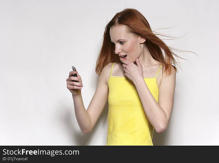 The young beautiful woman talks by a mobile phone. The young beautiful woman talks by a mobile phone