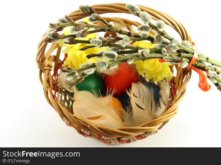 Easter basket, with colored eggs, over white background