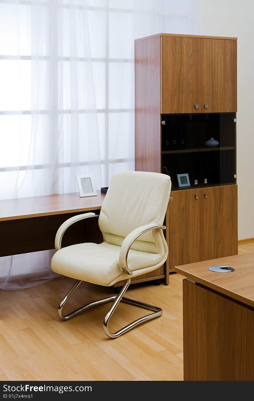 Table, chairs and bookcase at modern office