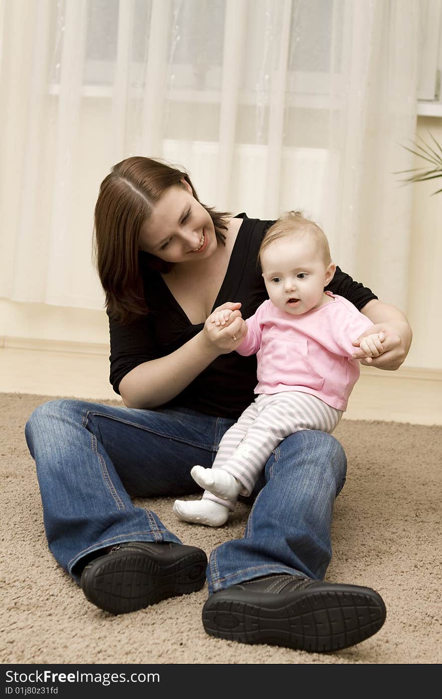 Mother And Baby Playing In Home