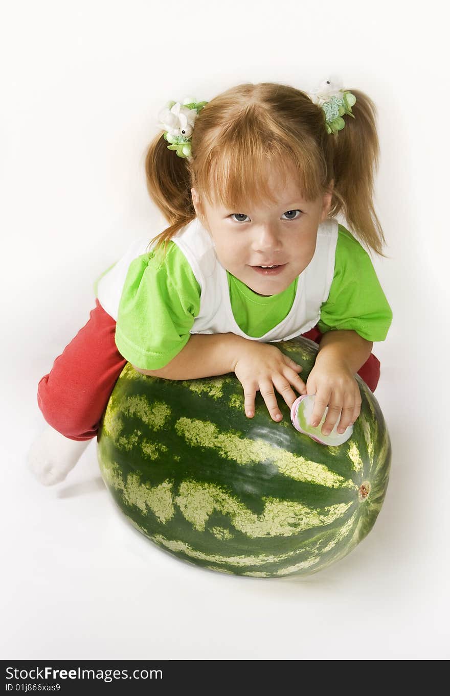 Small girl sits on top of the large watermelon. Small girl sits on top of the large watermelon