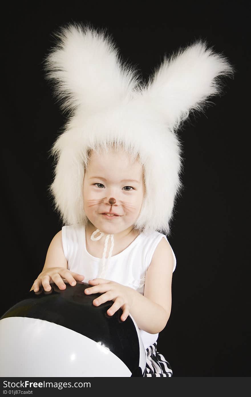 Little girl in a white downy bunny costume.