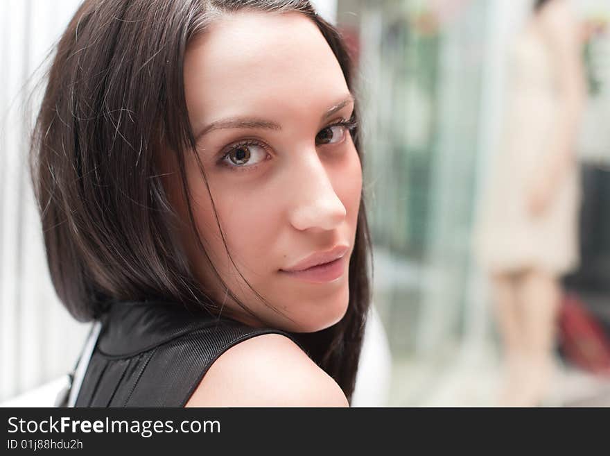 Attractive sexy brunette woman sitting in the shop. Attractive sexy brunette woman sitting in the shop