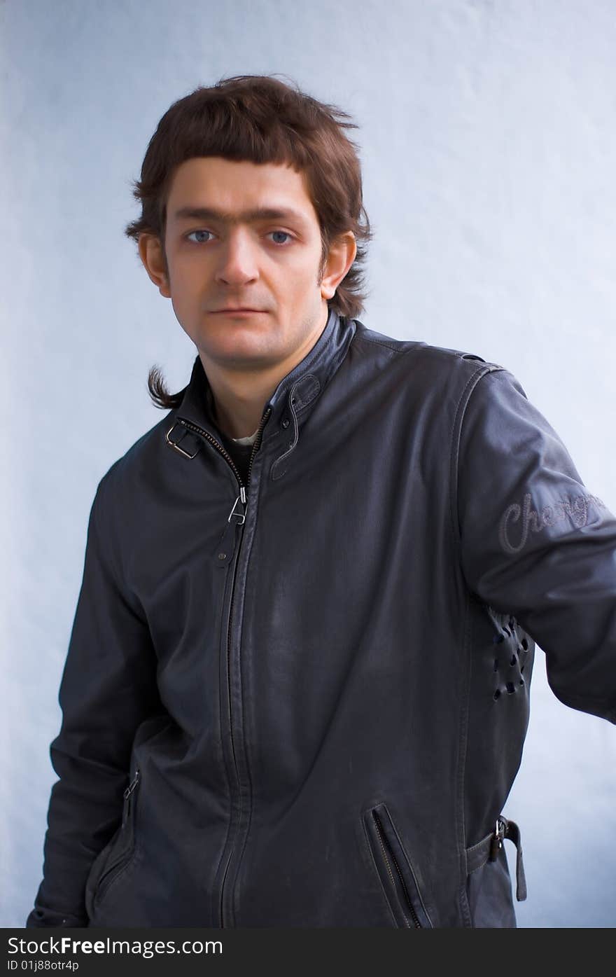 The young reflected person in a black leather jacket. The young reflected person in a black leather jacket.