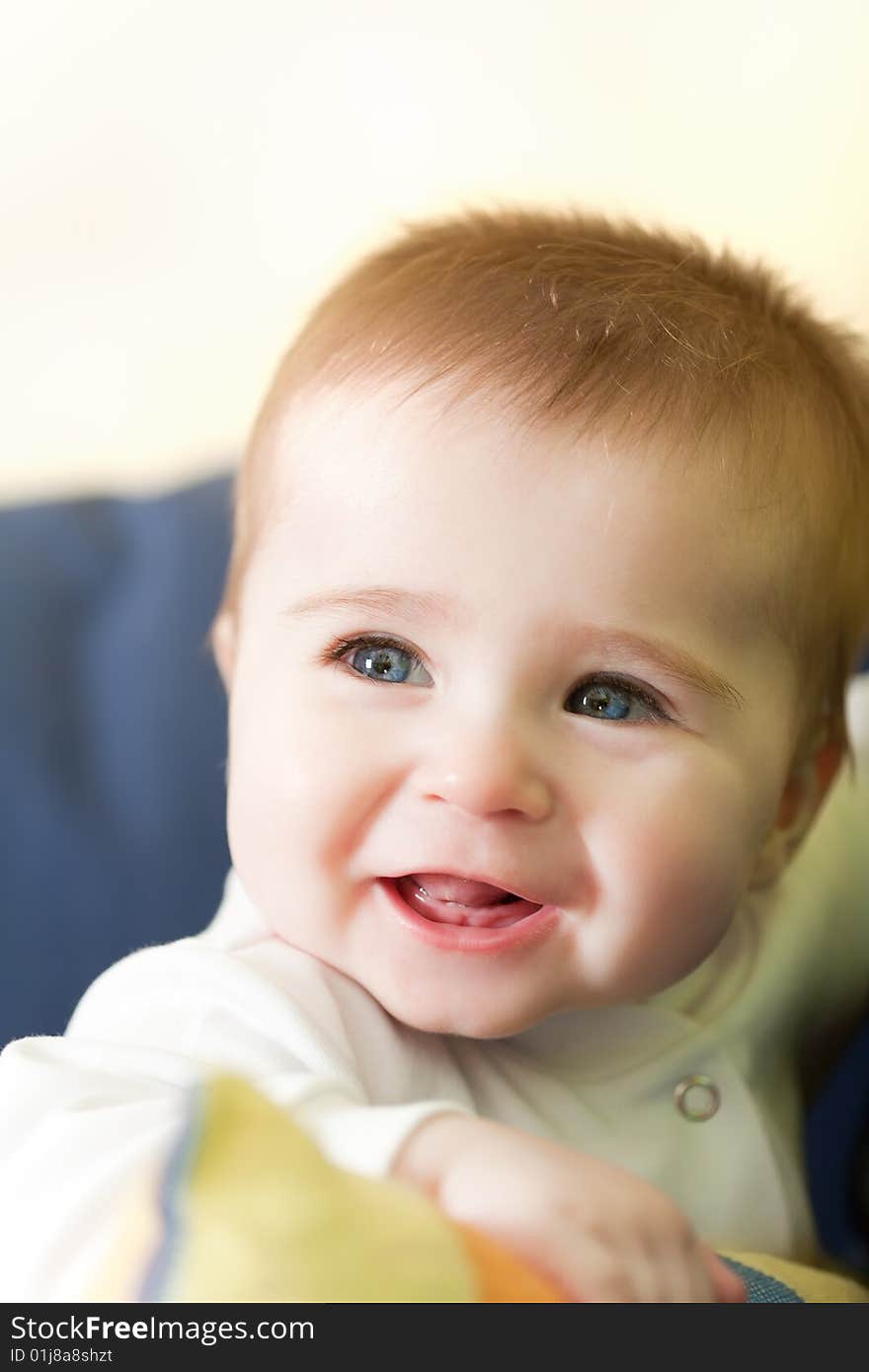 Portrait of joyful blue-eyes baby. Face close-up