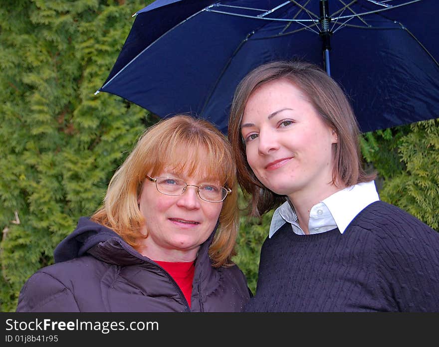 Mother and Adult Daughter Under Umbrella