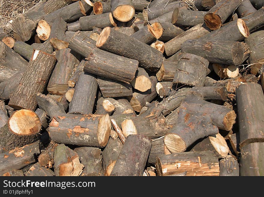 Cut wood in chaotic heap outdoor background. Cut wood in chaotic heap outdoor background