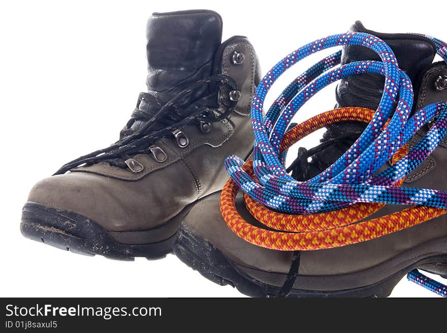 Pair of hiking boots and ropes on white background. Pair of hiking boots and ropes on white background