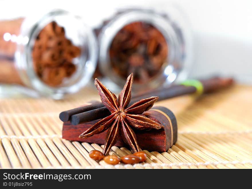 Close up anise star and wooded made chopstick in white background