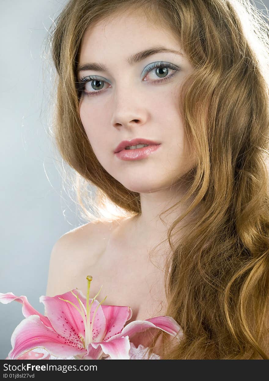 Beautiful young girl with lily flower