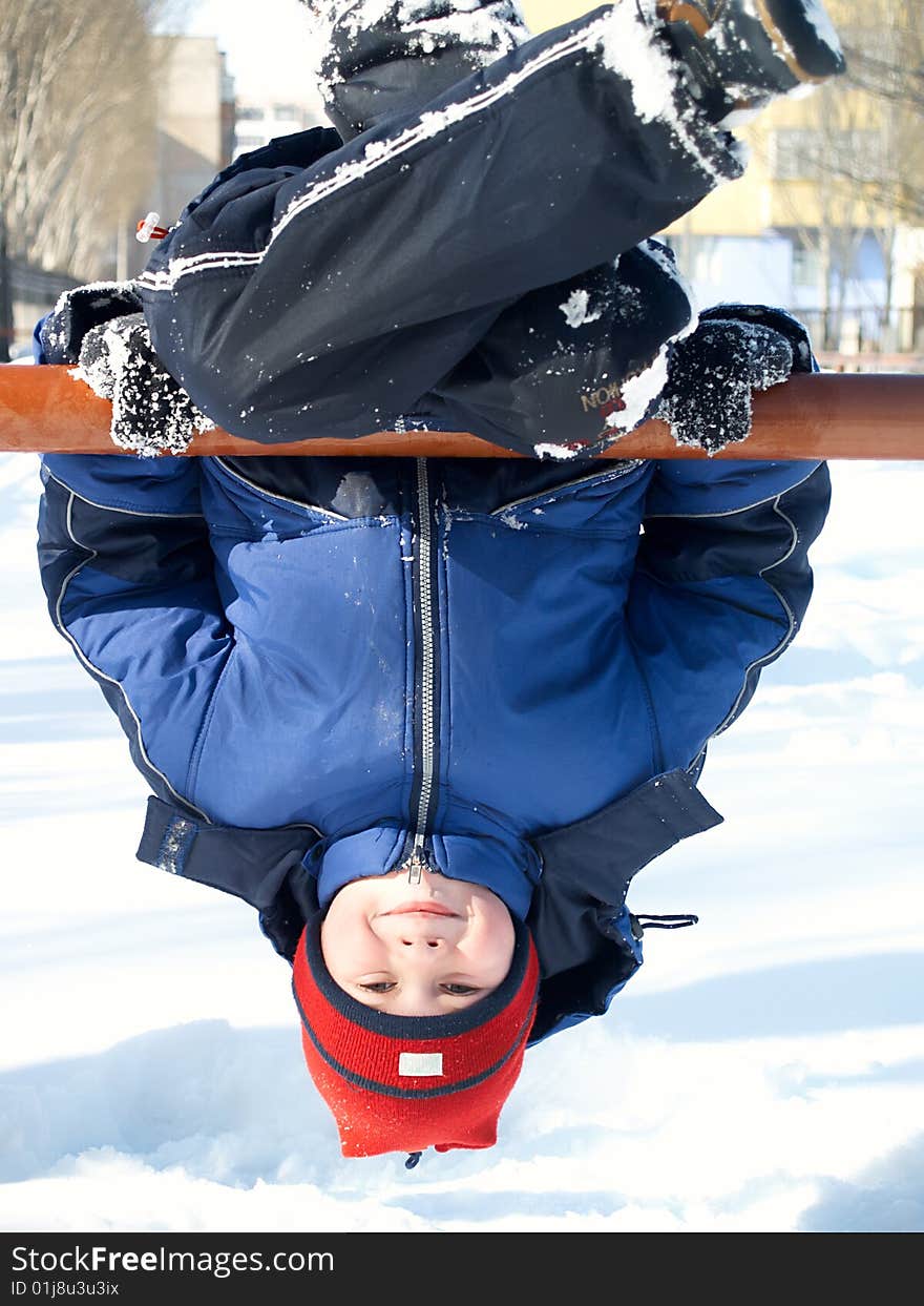 The child the boy plays in the winter in the street