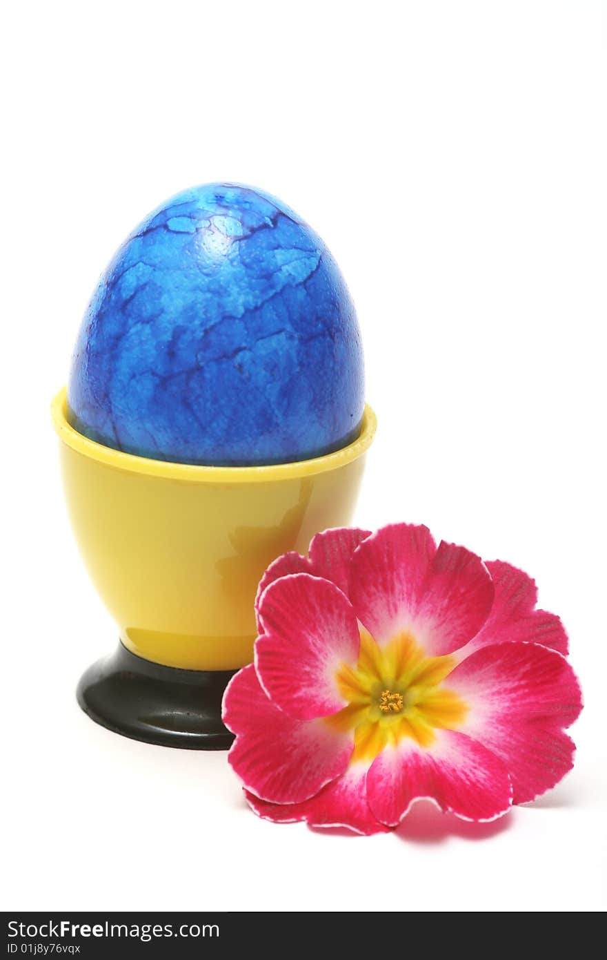 Blue easter egg with red flower on white background.