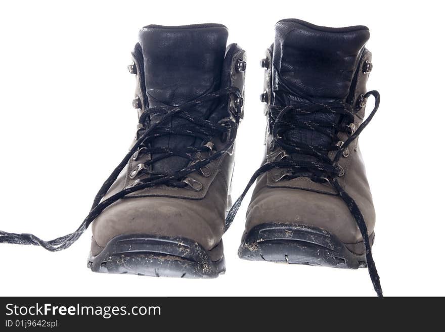 Pair of sturdy used hiking boots on white background