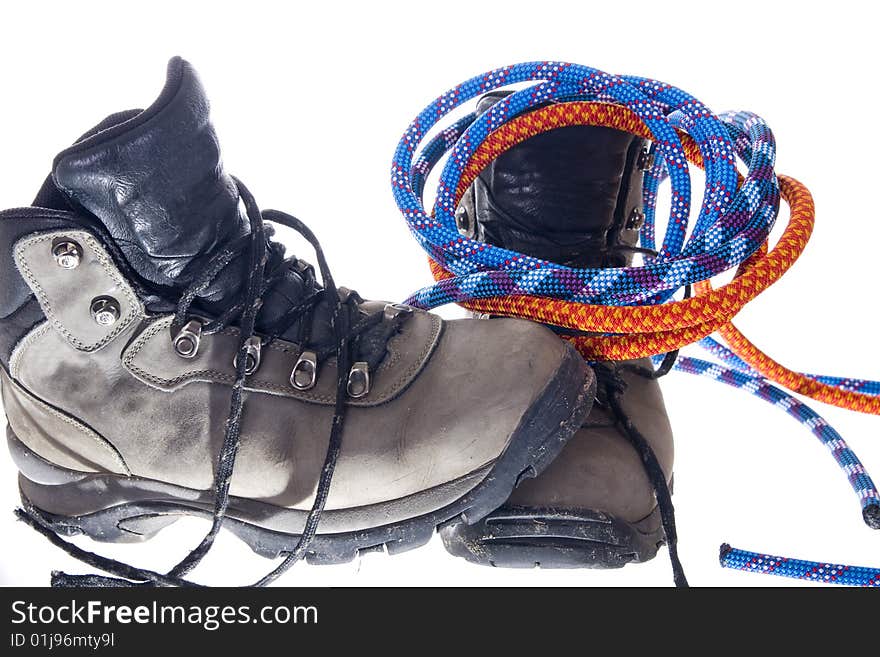 Pair of hiking boots and ropes on white background. Pair of hiking boots and ropes on white background