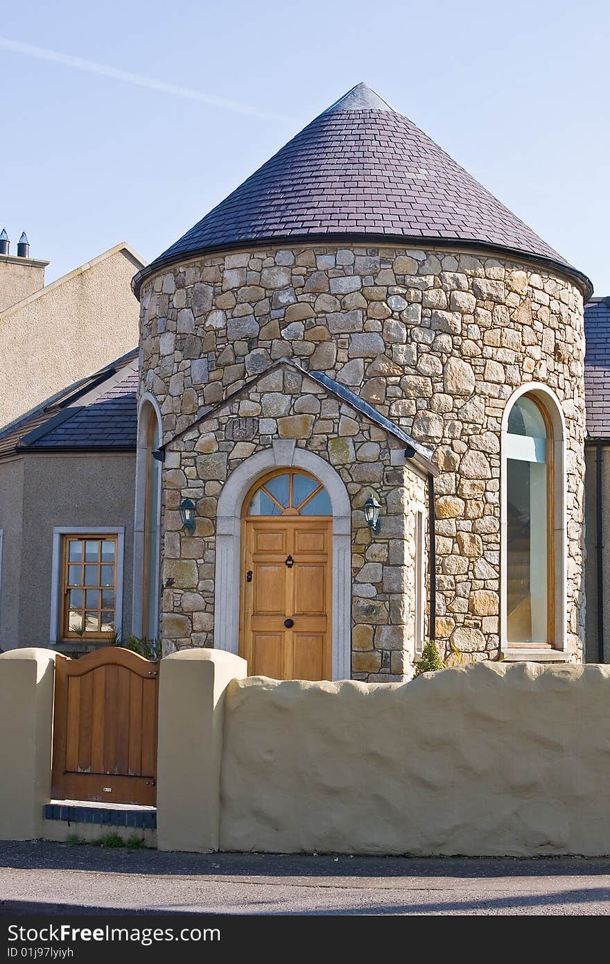 Old school house and gate against blue sky