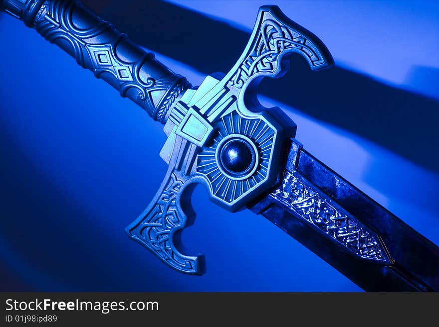 Photo of sword diagonally with a blue background. Photo of sword diagonally with a blue background