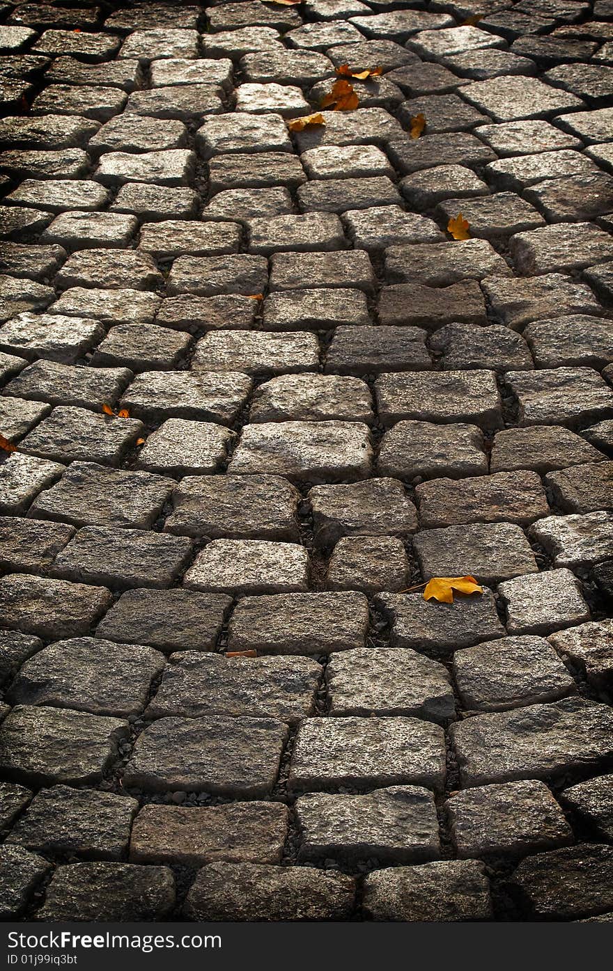 Aged cobblestone roadway. abstract background