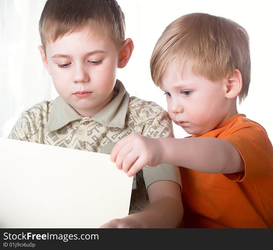 Two boys play on a white background. Two boys play on a white background