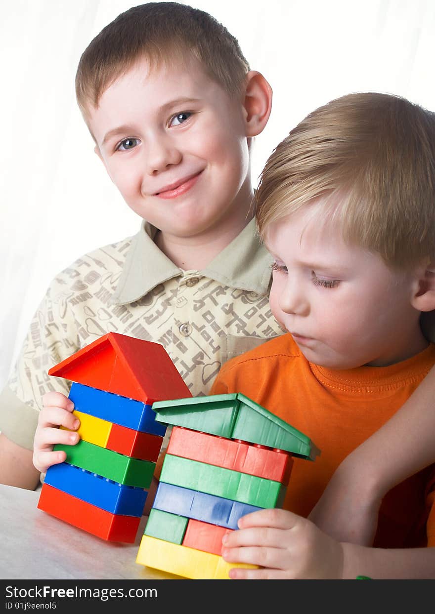 Two boys play on a white background. Two boys play on a white background