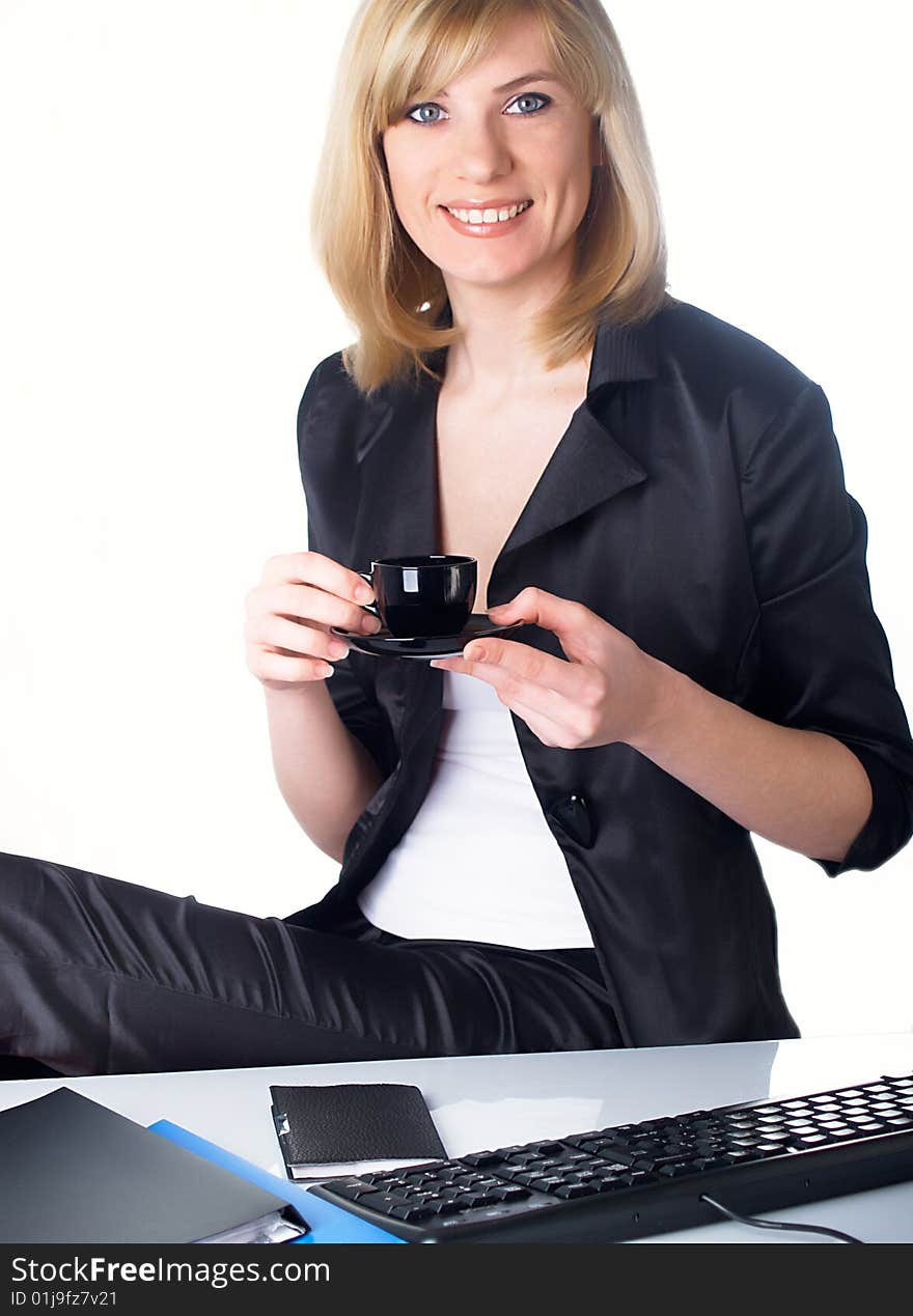 The beautiful girl behind a desktop. The beautiful girl behind a desktop