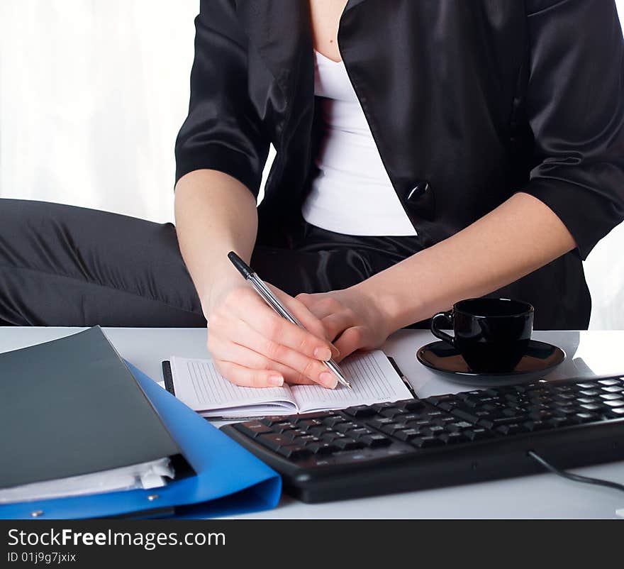 The beautiful girl behind a desktop. The beautiful girl behind a desktop