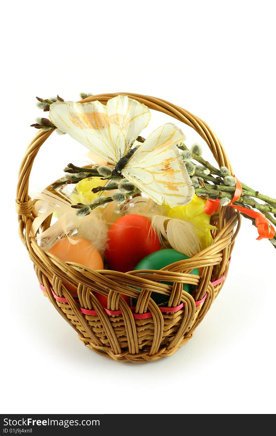 Easter basket, with  colored eggs, over white background