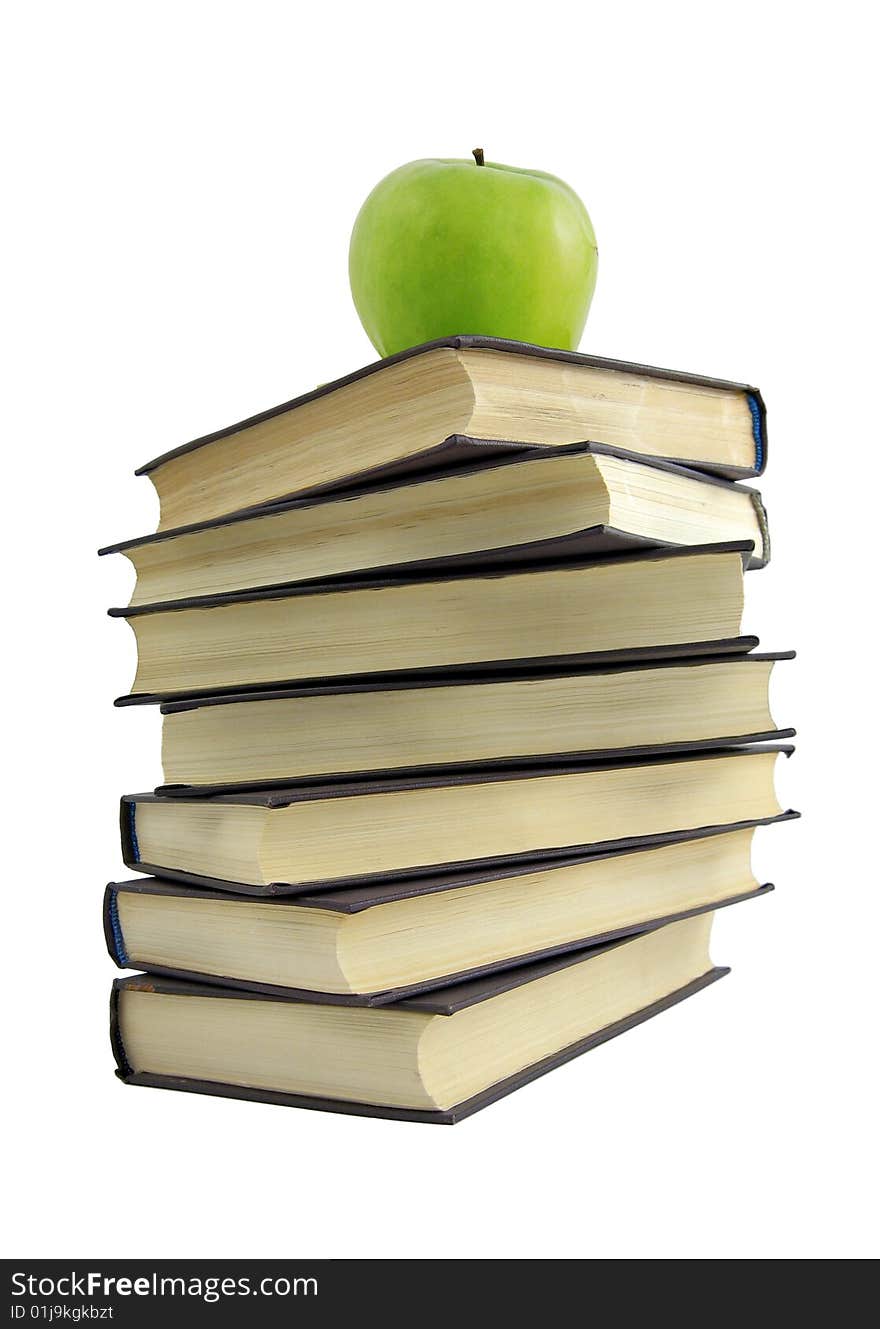 Book and green apple. White background